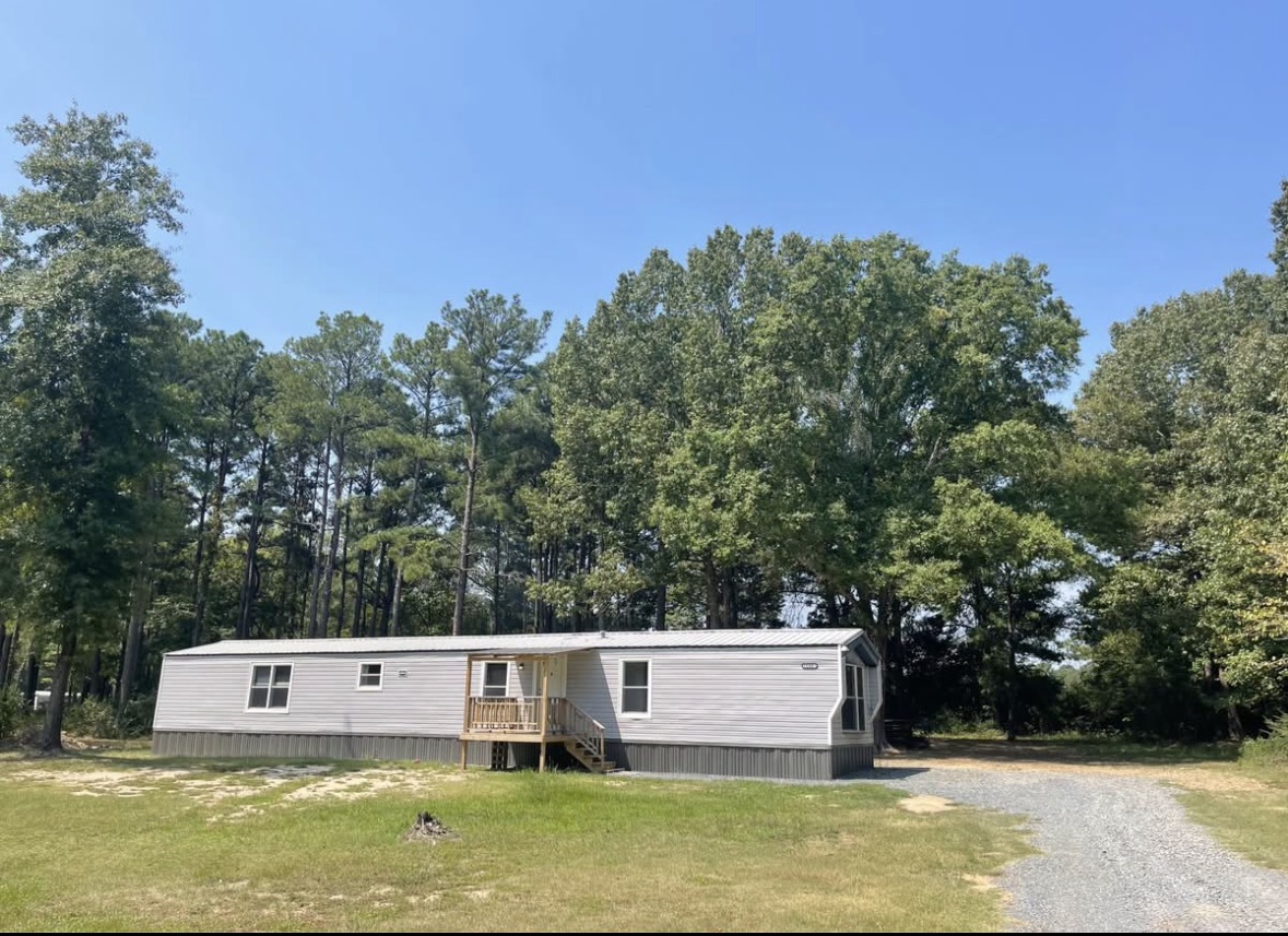 Mobile home with driveway and lawn